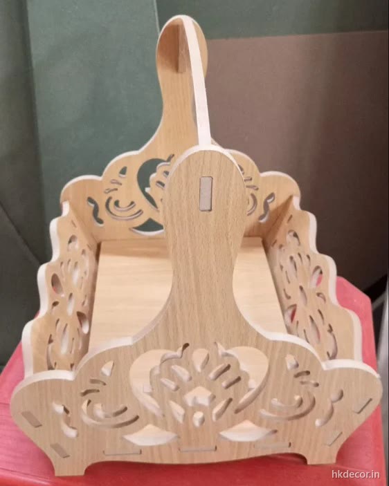 Laser cut jhula swing with a perforated motif cut through the back and side panels, natural board