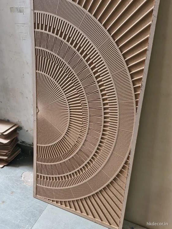 CNC carved door panel with a radial fan relief in raw board straight off the router bed