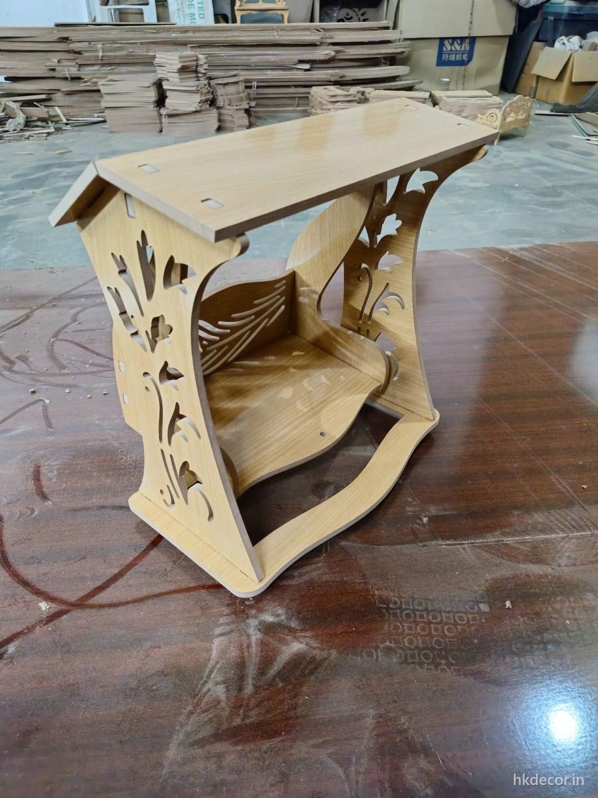 Laser cut flat-pack console piece assembled from slotted parts in natural board
