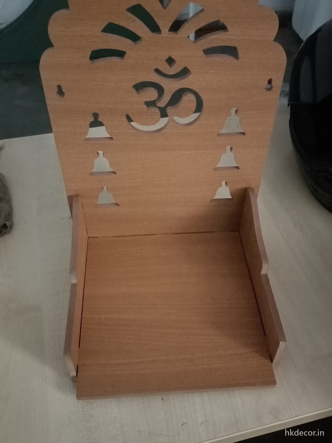 Laser cut home mandir with an open shelf and a cut arch, light wood finish
