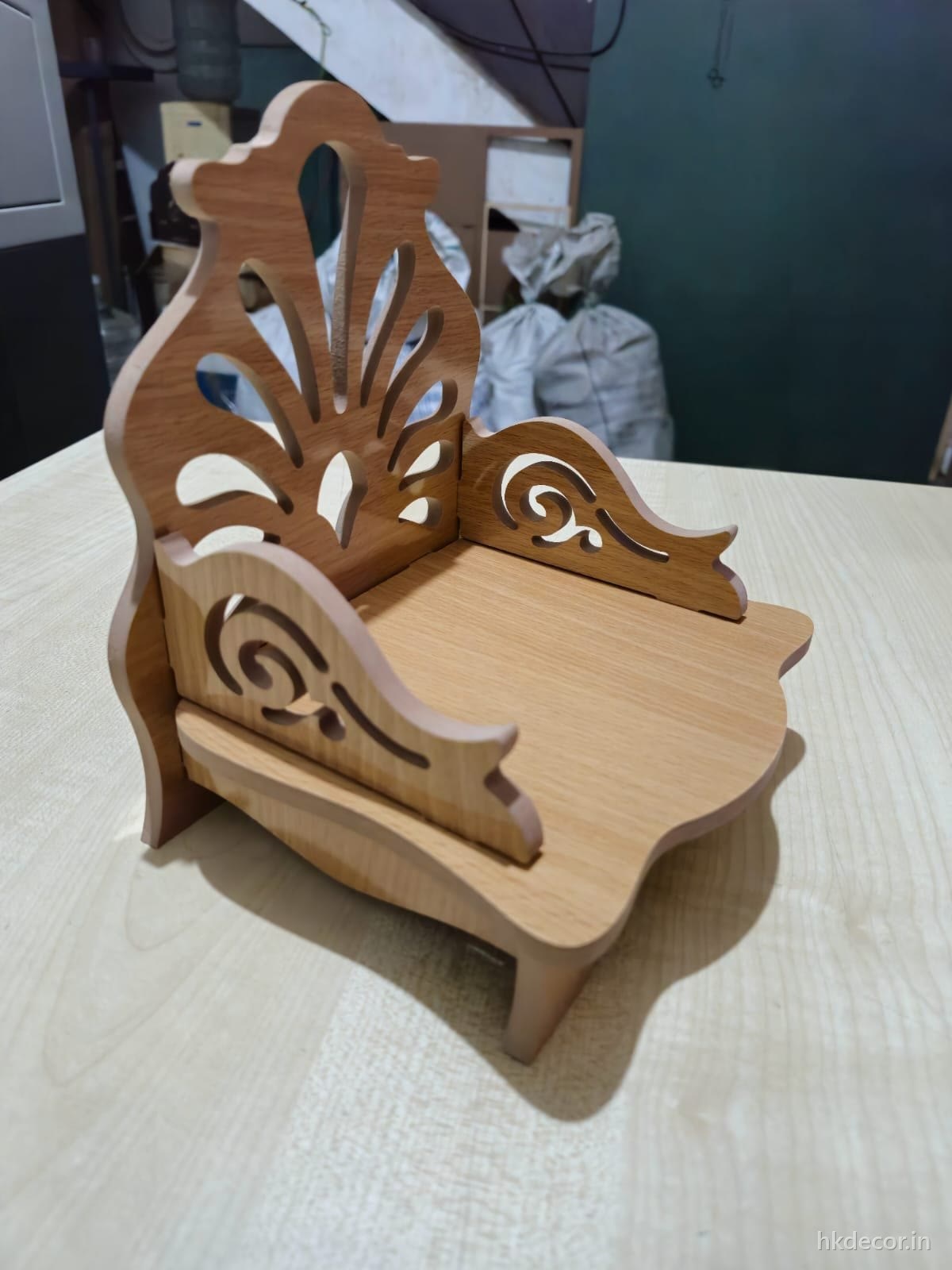 Laser cut swing seat with scrolled perforated sides in natural board