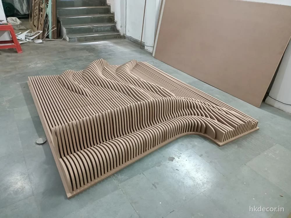 Parametric wall panel built from stacked CNC cut ribs forming a flowing three-dimensional surface, Dream3 Bijwasan