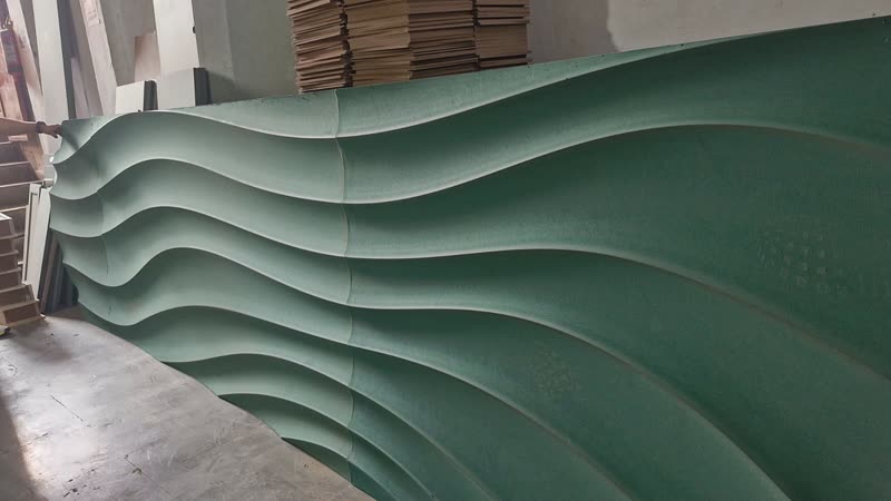 Close up of a CNC cut parametric wall panel showing rib pitch and wave flow across the face