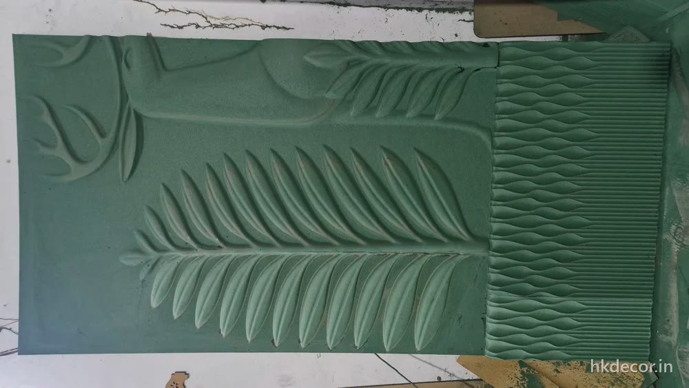 CNC carved banana leaf relief across a wide wall panel, primed