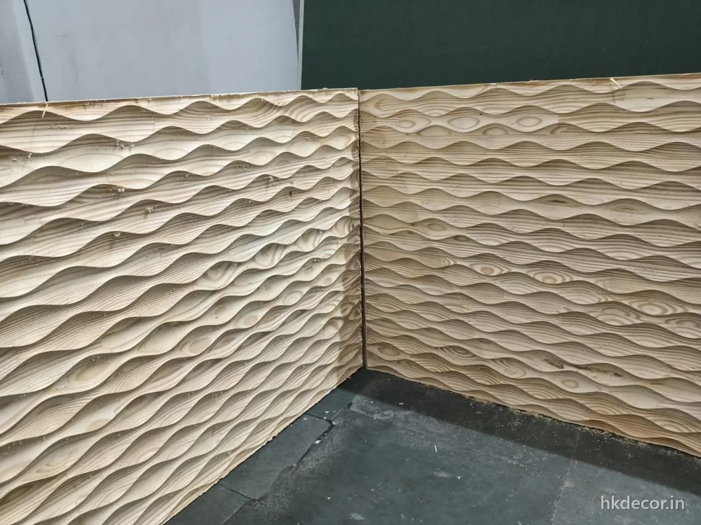 CNC cut 3D wave wall panels meeting at a corner with the wave carried across the joint